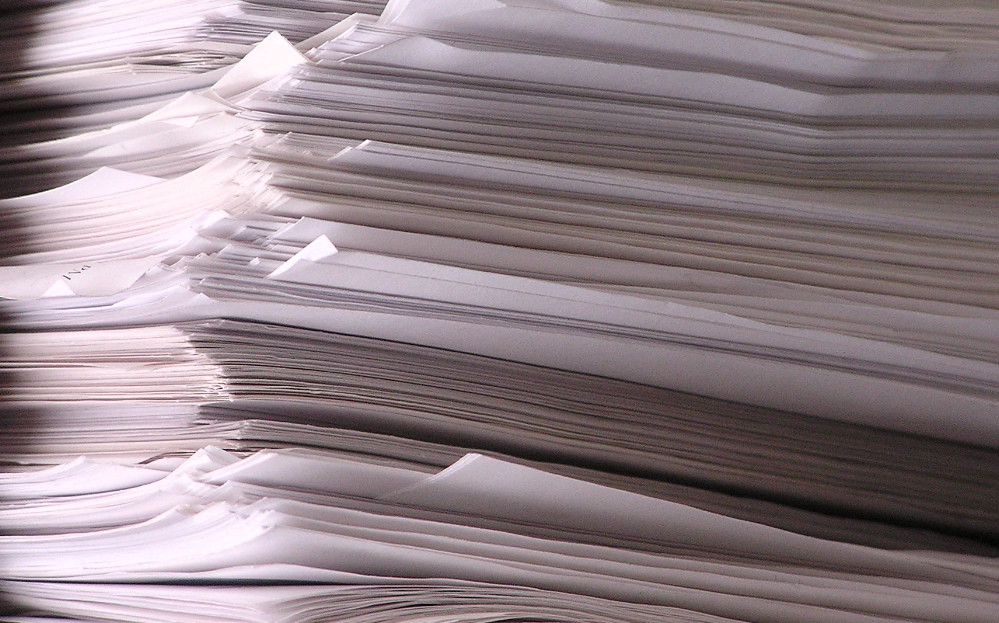 Pile de documents papier en gros plan, symbole de la gestion documentaire