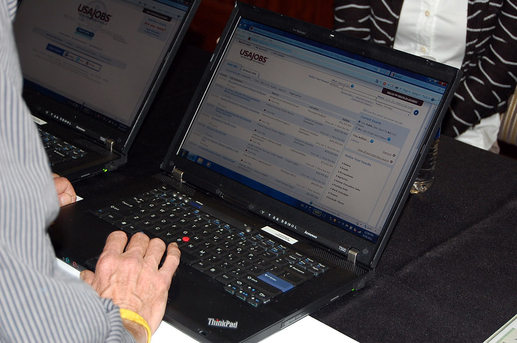 Salon de l'emploi avec candidats ingénieurs rencontrant des recruteurs sur un job fair